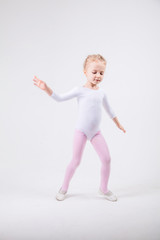 Happy little girl dancing isolated on white background