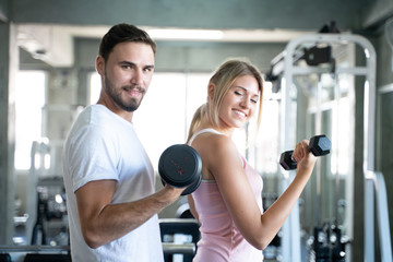 Fototapeta premium Healthy lifestyle couple working out in fitness gym
