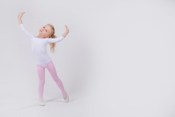 Happy little girl dancing isolated on white background