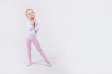 Happy little girl dancing isolated on white background