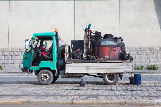 City Prague, Czech Republic.  The repair is in progress. A working car with a pitch stands next to it. 2019. 26. April. Travel photo.
