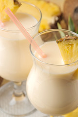 Cocktail Pina Colada. Pina Colada refreshing summer alcoholic cocktail with coconut milk and pineapple juice nearby. summer drink. cocktail preparation. on natural wooden background. close-up