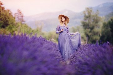 Beautiful girl walks among lavender fields, France, Provence