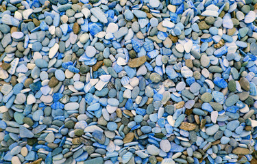 Multicolored round pebbles on the beach. Beautiful background