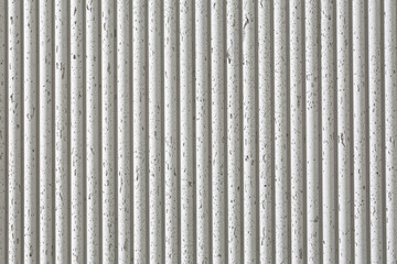 Old white ribbed concrete wall texture background. Horizontal picture.