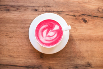 Fototapeta na wymiar Cup of trendy beetroot latte on table.