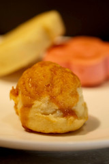 Chinese pastry with golden yolk thread inside on white plate, special recipe sweet, high sugar level that affect illness such as diabetes, served with sugar or tea, sold in market and restaurant