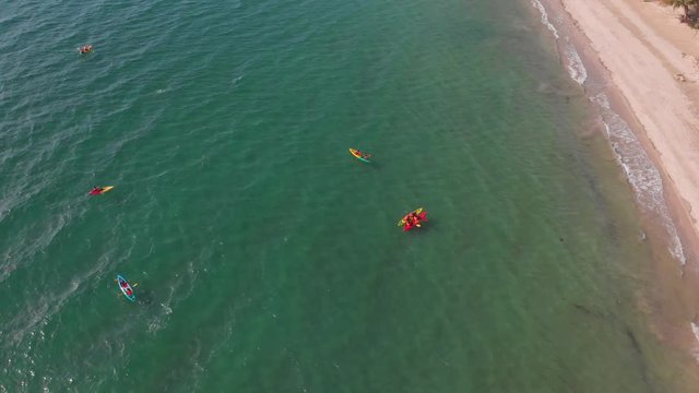 Aerial Top View of a Sandy Beach With Turquoise Water and visitor in kayaking around beach at Labuan, Malaysia