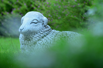 Sheep statue on a green lawn