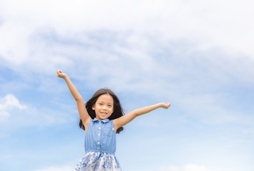Happy beautiful child little girl white could and blue sky background with copy space