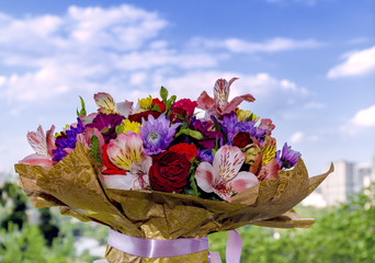 beautiful bouquet with different bright colors on a wooden background.