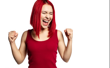 Portrait of happy excited young woman feeling cheerful about something. Beautiful girl dressed in red shirt. Happiness and beauty concept. Copy space in right side. Isolated on white