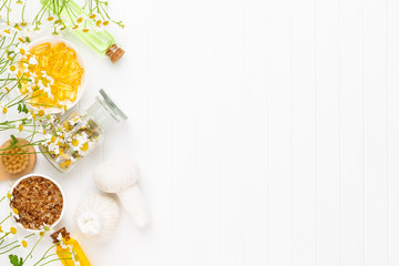 Spa still life with aromatherapy chamomile, herbal oil, soap, sea salt.