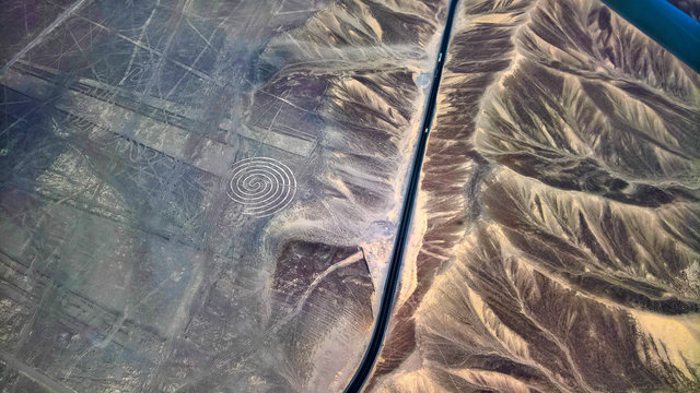 Aerial airplane panoramic view to Nazca geoglyph lines aka spiral, Ica, Peru