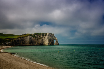 Naklejka premium Etretat is best known for its white chalk cliffs, including natural arches. Normandy, France, Europe