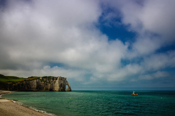 Fototapeta premium Etretat is best known for its white chalk cliffs, including natural arches. Normandy, France, Europe