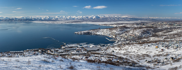 Winter panoramic view of Petropavlovsk-Kamchatsky City, Avacha Bay, Pacific Ocean and seaport on clear sunny day, good weather to explore surroundings to horizon. Russian Far East, Kamchatka Peninsula
