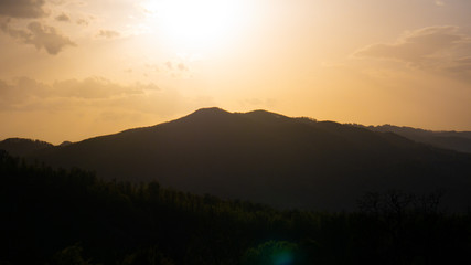 Beautiful landscape in the mountains at sunset. View of colorful sky with amazing clouds.