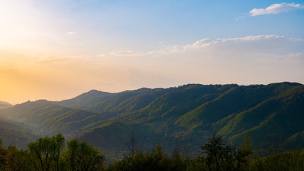Beautiful landscape in the mountains at sunset. View of colorful sky with amazing clouds.