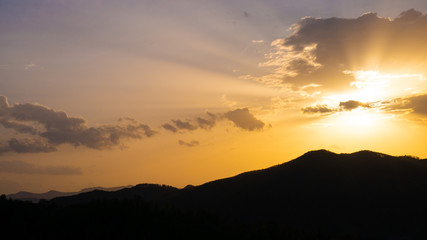 Beautiful landscape in the mountains at sunset. View of colorful sky with amazing clouds.