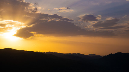 Beautiful landscape in the mountains at sunset. View of colorful sky with amazing clouds.