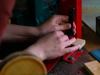 Leather workshop Hands of the girl Red leather