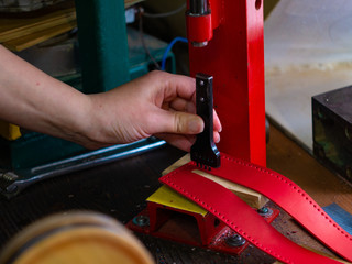 Leather workshop Hands of the girl Red leather