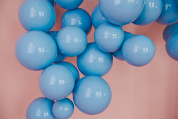 Blue balls on a pink background. Wedding or birthday decoration. Bright background