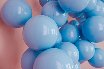 Blue balls on a pink background. Wedding or birthday decoration. Bright background
