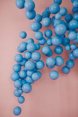 Blue balls on a pink background. Wedding or birthday decoration. Bright background