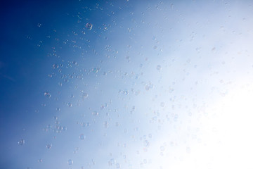 Soap bubbles fly in the blue sky