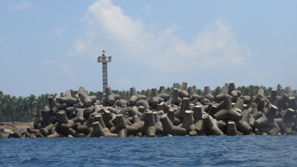 lighthouse on rock in sea