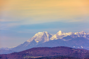 Plakat Mountain landscape in the evening. Mountain range covered with snow against a gradient sunset sky