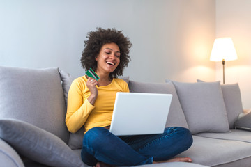 Naklejka premium Beautiful mixed-race woman shopping on internet