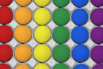 Colorful chicken eggs painted in the style of the Rainbow flag LGBT. Chicken eggs in carton box. Top view painted eggs LGBT gay flag background. View from above