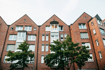 Fototapeta na wymiar Residential buildings in Muenster in Germany. Ordinary houses in urban area. Apartment buildings in a row.