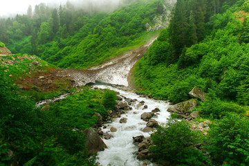 Glacier at Kackarlar melts and creates stream under partial light. Ayder, Rize / Turkey