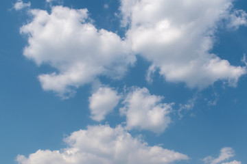 Naklejka na ściany i meble Beautiful fluffy clouds in the blue sky