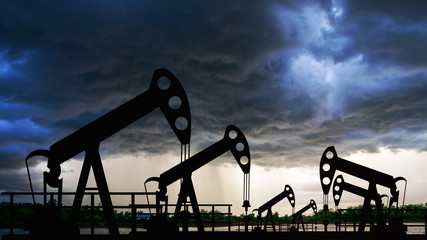 Oil pump oil rig energy industrial machine for petroleum in the sunset