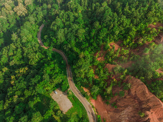 Top View of Rural Road, Path through the green forest and countryside of Thailand, Top view aerial photo from drone