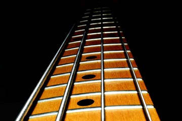 Four string bass guitar neck with black background