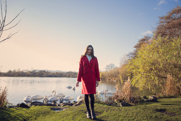 Fototapeta premium Woman walking by lake