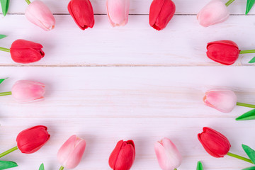 Women's day, Mother's day, Valentine's day concept Red and pink tulips bouquet on white wooden background, top view and copy space for card and advertiser.