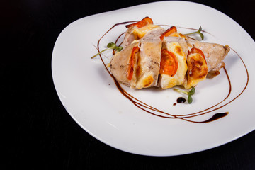 Spicy chicken fillet baked with bacon, tomatoes and cheddar cheese
