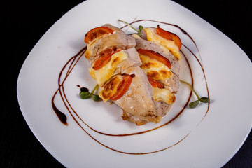 Spicy chicken fillet baked with bacon, tomatoes and cheddar cheese