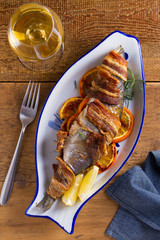 Grilled Bacon-Wrapped Whitefish. Fish wrapped with bacon. View from above, top