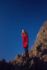 Naklejka na ściany i meble Woman on a cliff edge (photographed entirely safely)