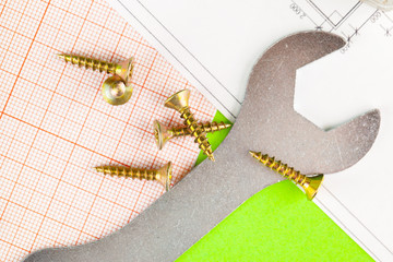 technology and metalworking. Metal bolt and nut on printed drawings background