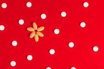 Top view of pharmaceutical medicine pills on red background