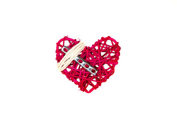 A heart, a steel orthopedic surgical plate, and white string